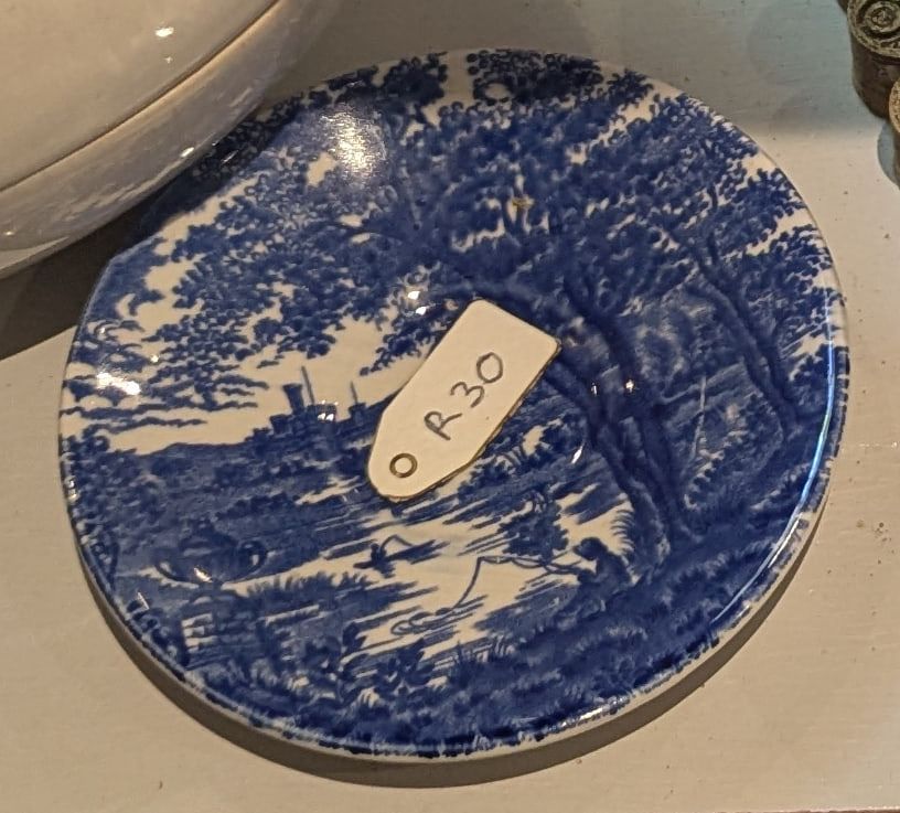 A blue and white transfer-printed saucer
