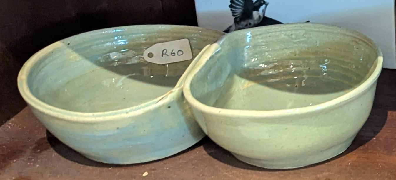 A pale green glazed double bowl