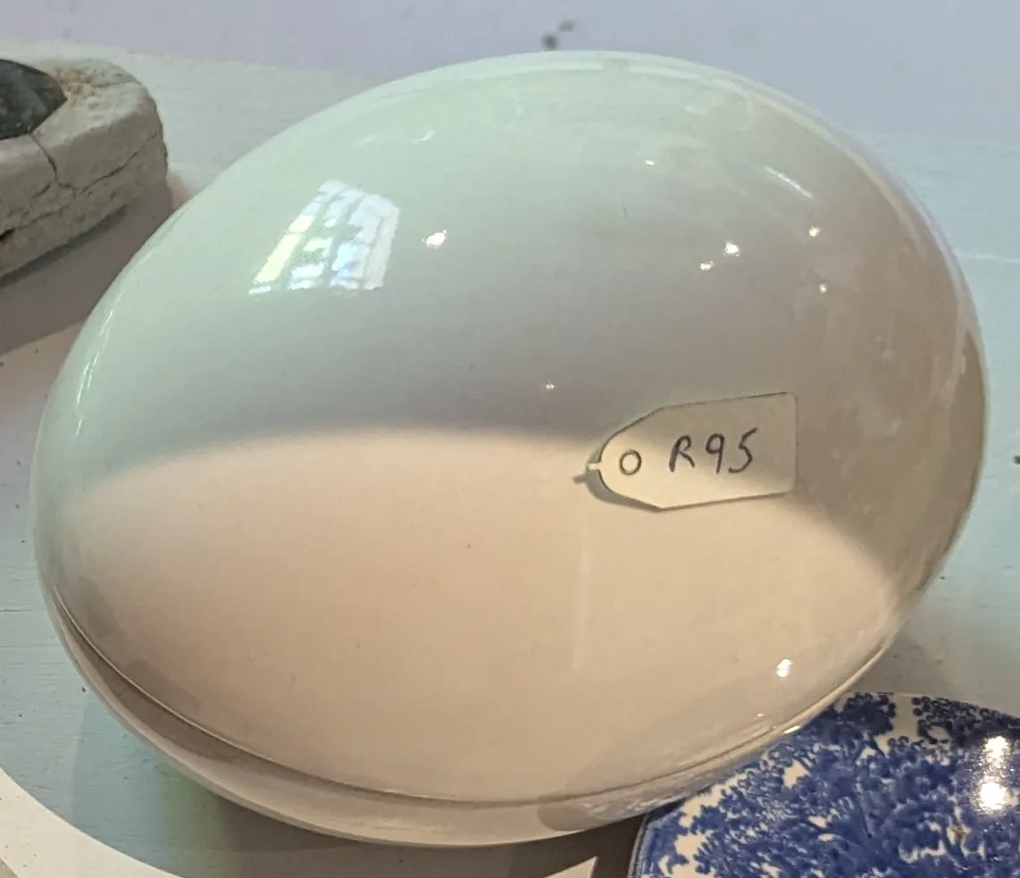 A large white glazed ceramic egg-shaped box