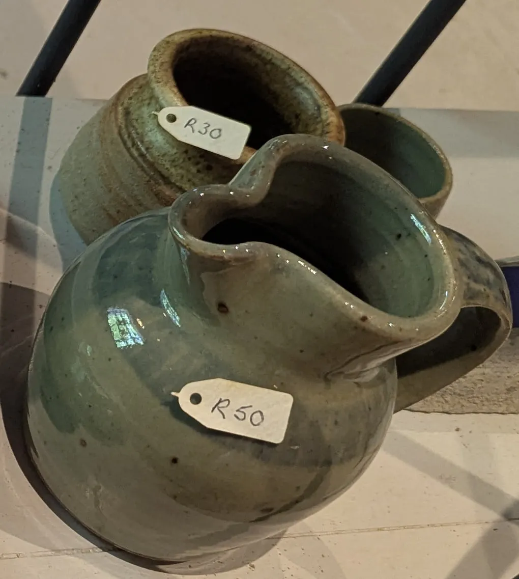 A hand-thrown jug in mottled green glaze