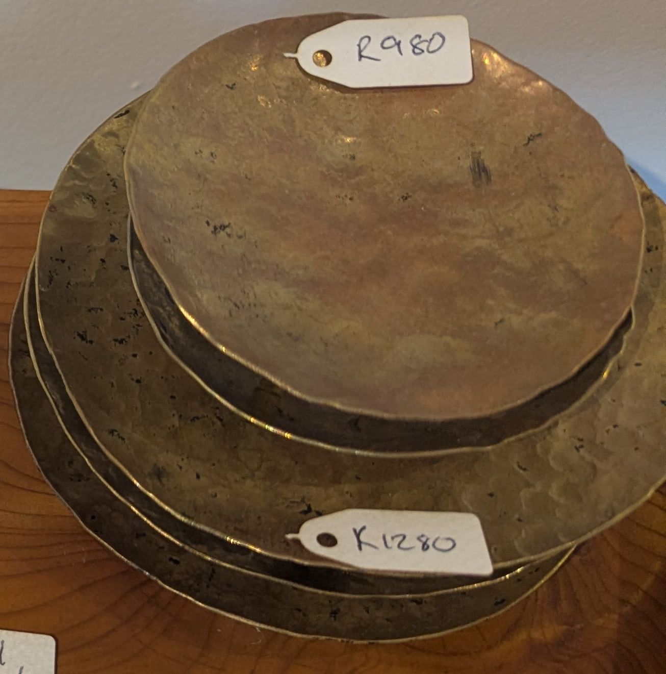 Hand-hammered brass plates with dark fire marks