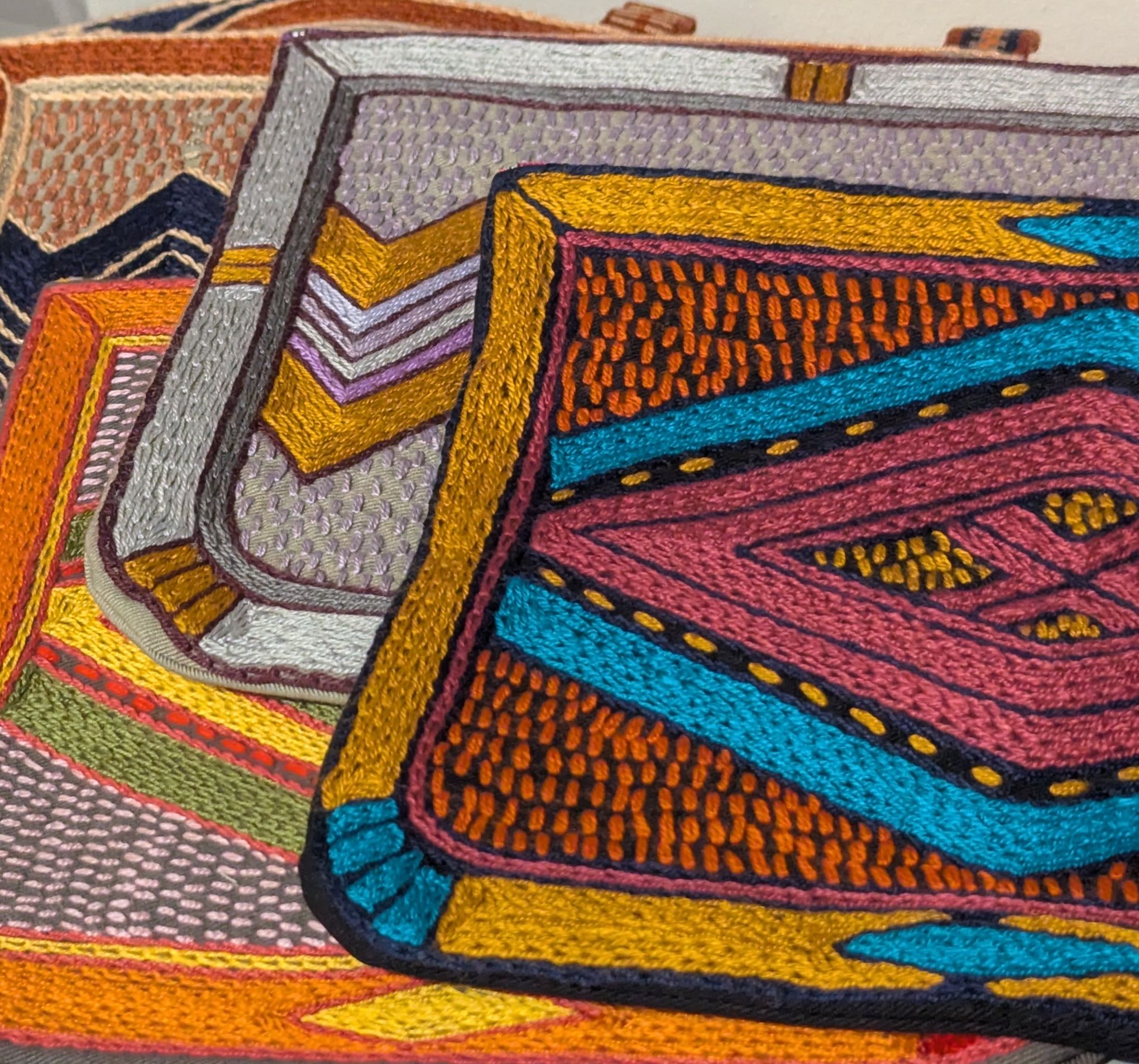 Bags covered in bright geometric hand embroidery