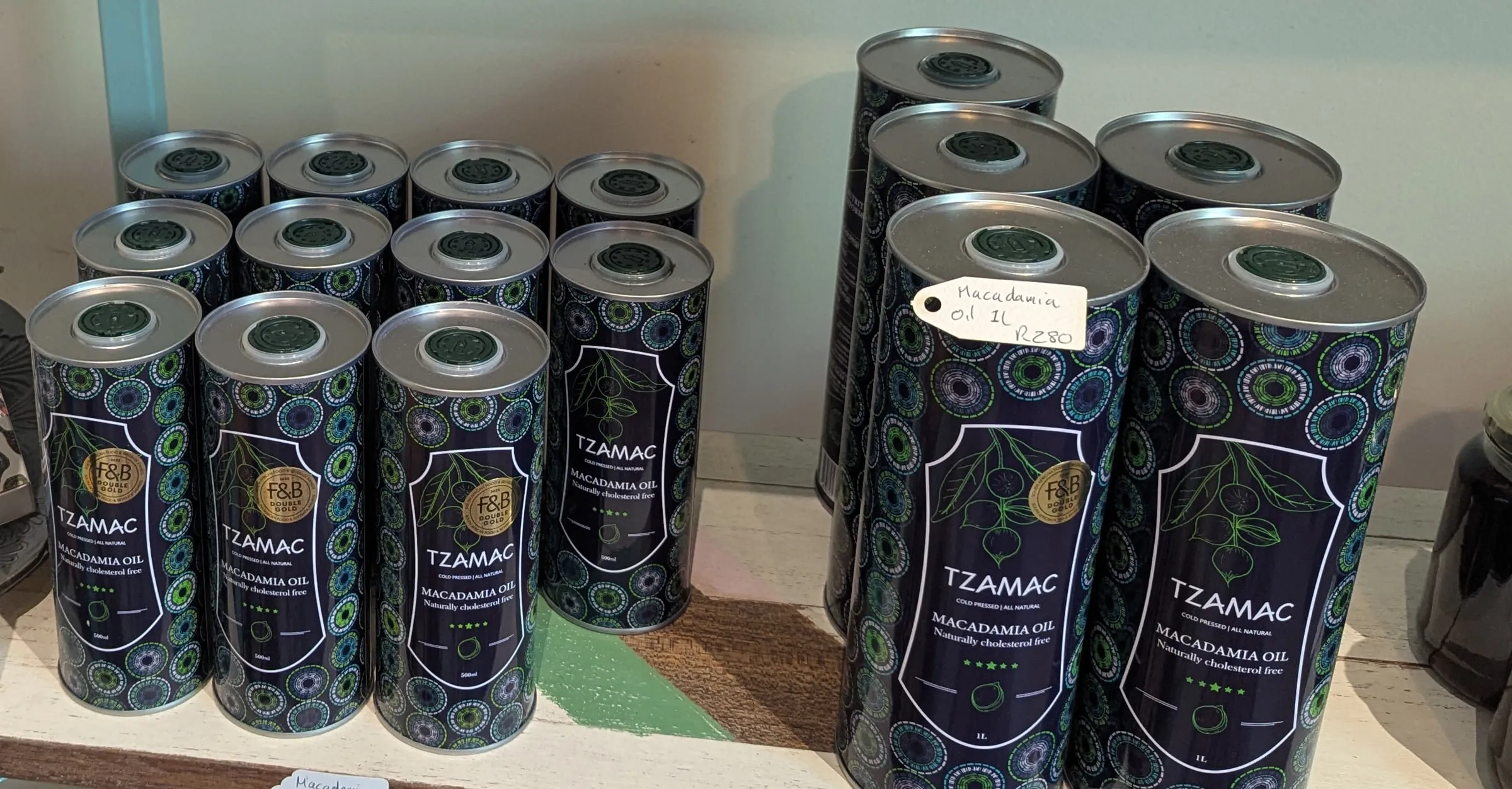 Navy TZAMAC macadamia oil tins with a botanical pattern in two sizes