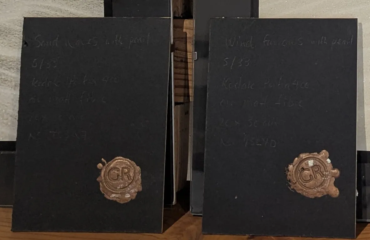 Two black cards with copper GR wax seals, part of the Sandforms prints