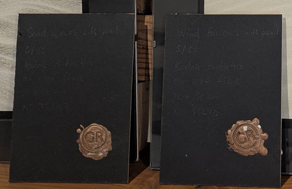 Two black cards with copper GR wax seals, part of the Sandforms prints